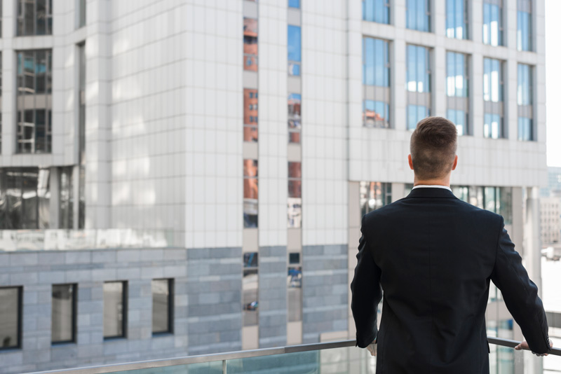 businessman-looking-building